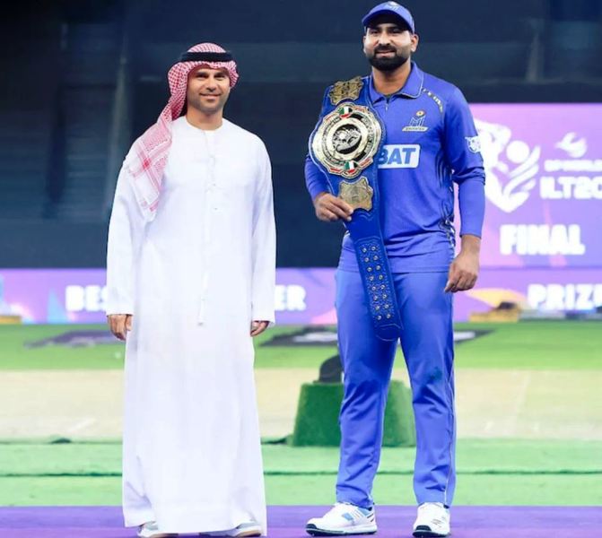Muhammad Waseem, who became the UAE's best player in the 2024 International League T20, poses wearing a blue belt.