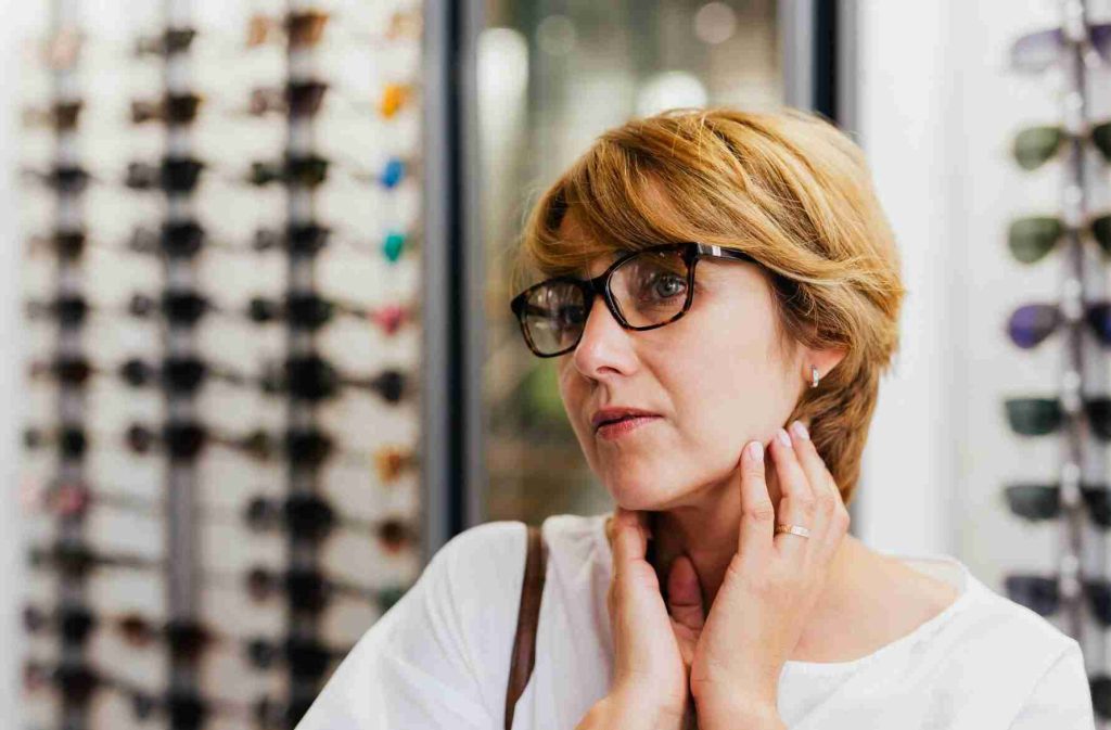 Woman choosing glasses to impress others