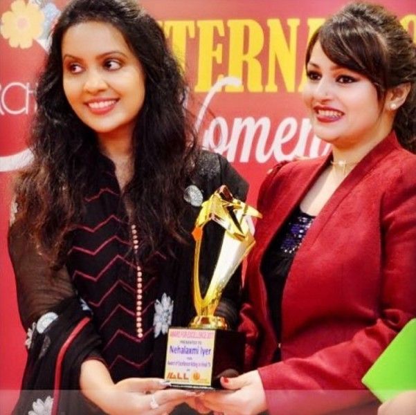 Nehalaxmi Iyer (right) receives the Excellence Award.