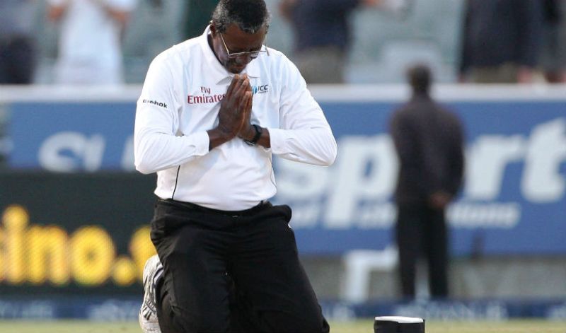 Steve Bucknor kneels in prayer during the final Test between South Africa and Australia in Cape Town on March 22, 2009.