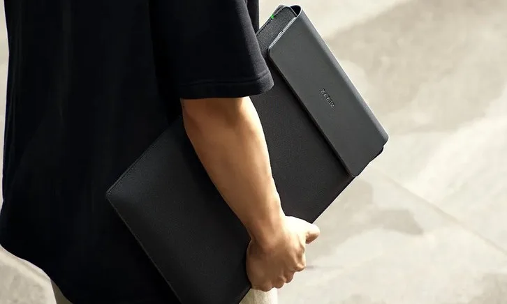 Razer's expensive new laptop sleeve is a wireless charging mat in disguise. 2 bag, briefcase, person