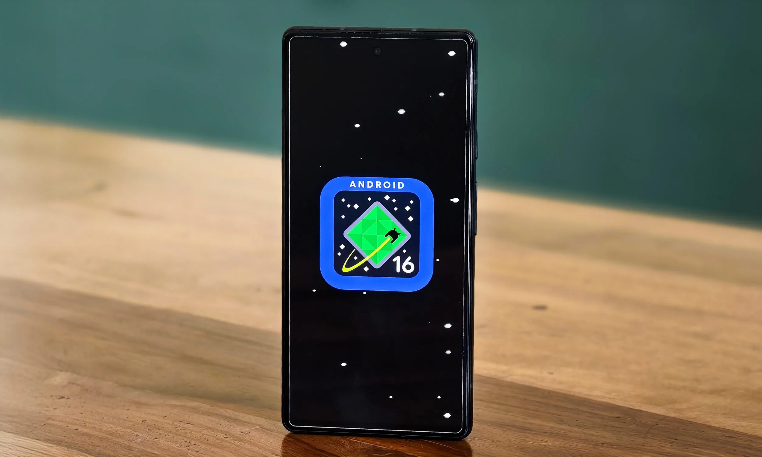 Android 16 logo on Google Pixel 6a standing on a table