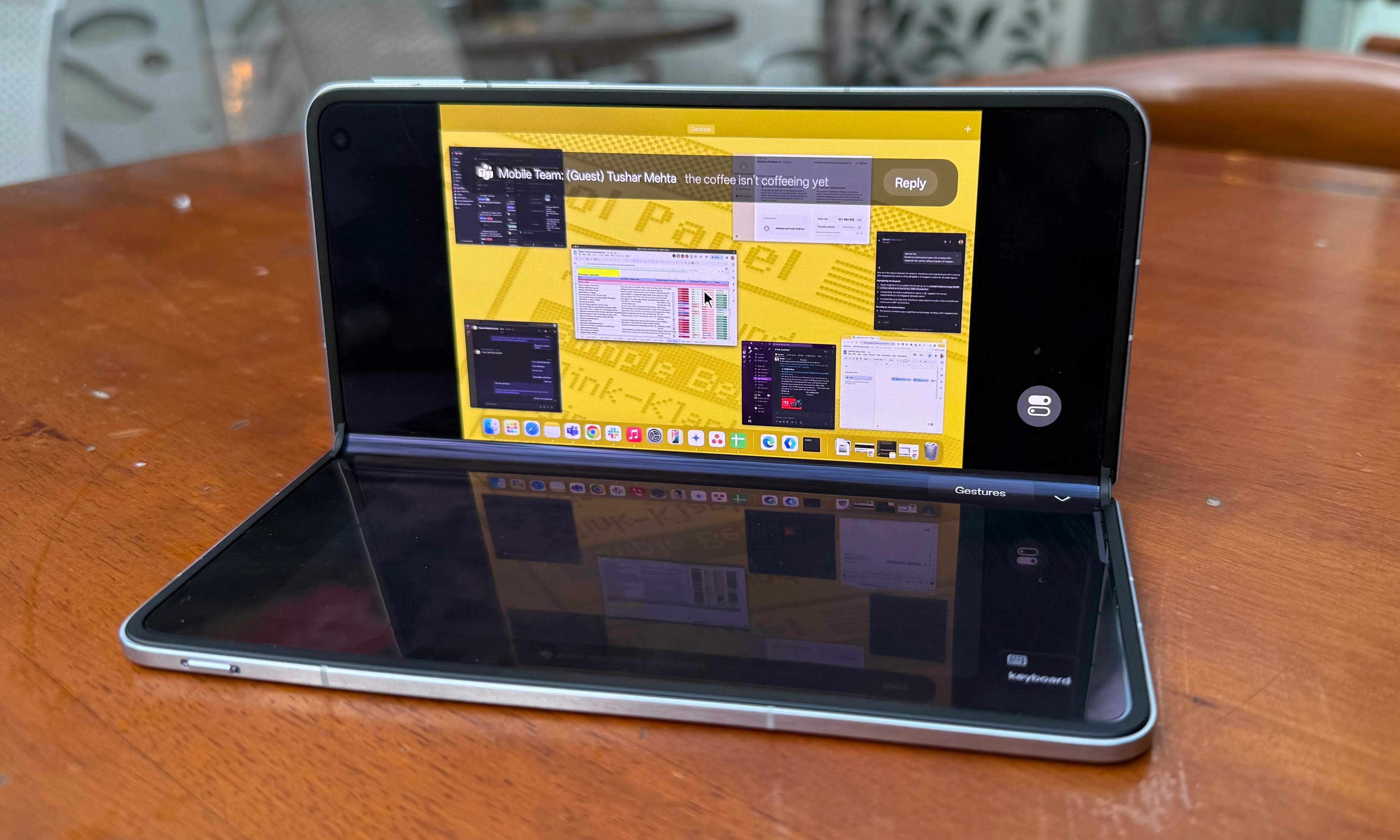 An individual is remotely operating a Mac from Oppo Find N5.