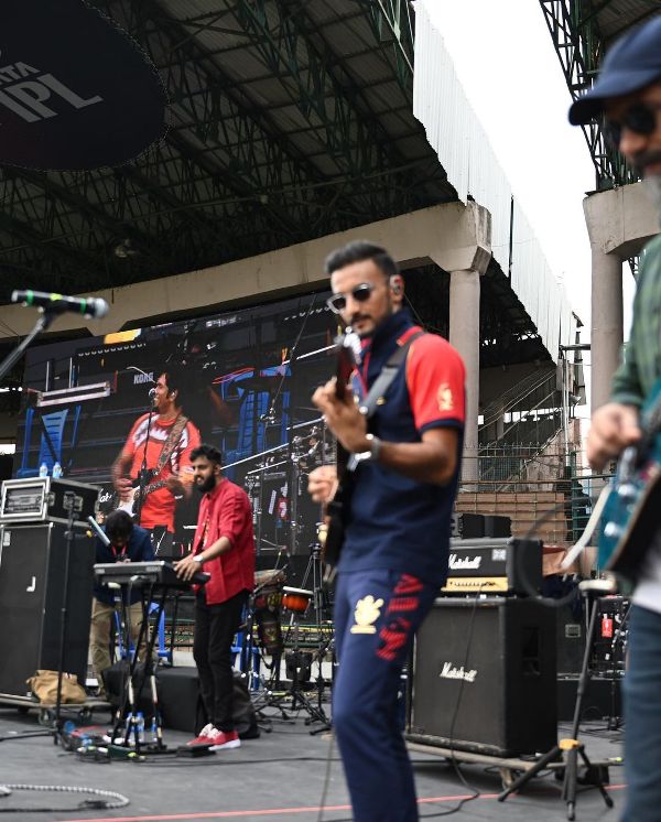 Harshal Patel playing guitar in concert