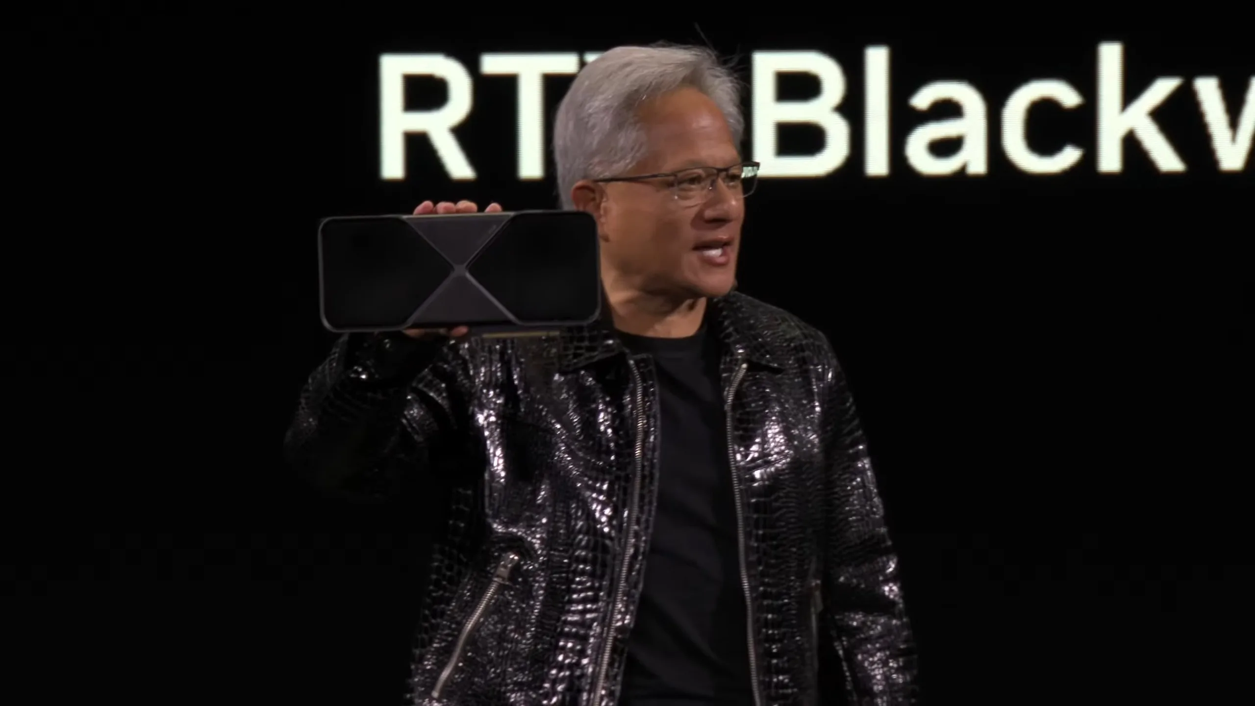 Nvidia CEO Jensen Huang shows off the RTX 5090 at CES 2025.
