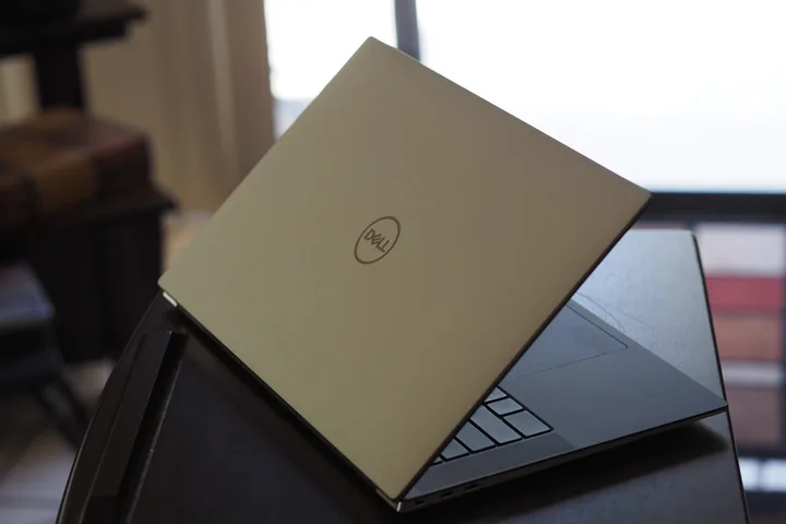 The Dell XPS 15 was slightly opened on the table.