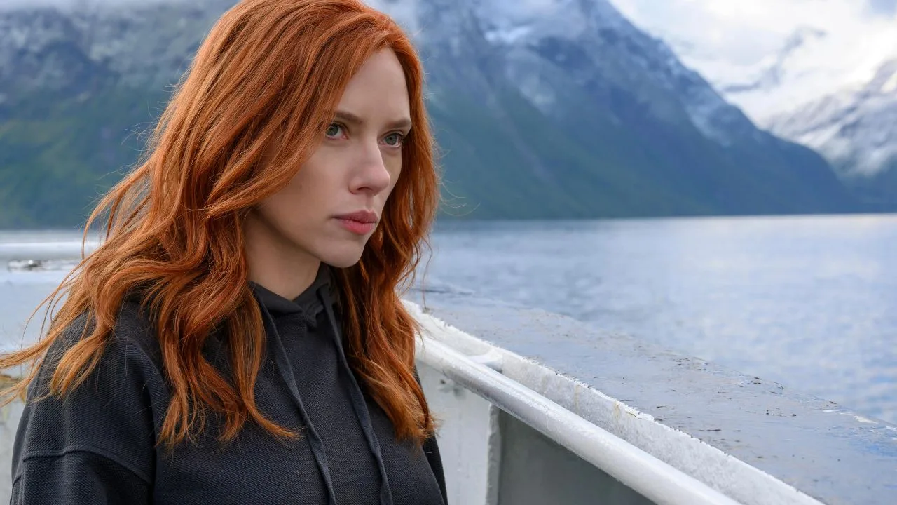 Natasha Romanoff (Scarlett Johansson) looks into the distance with a pensive expression in the Marvel Studios film Black Widow.